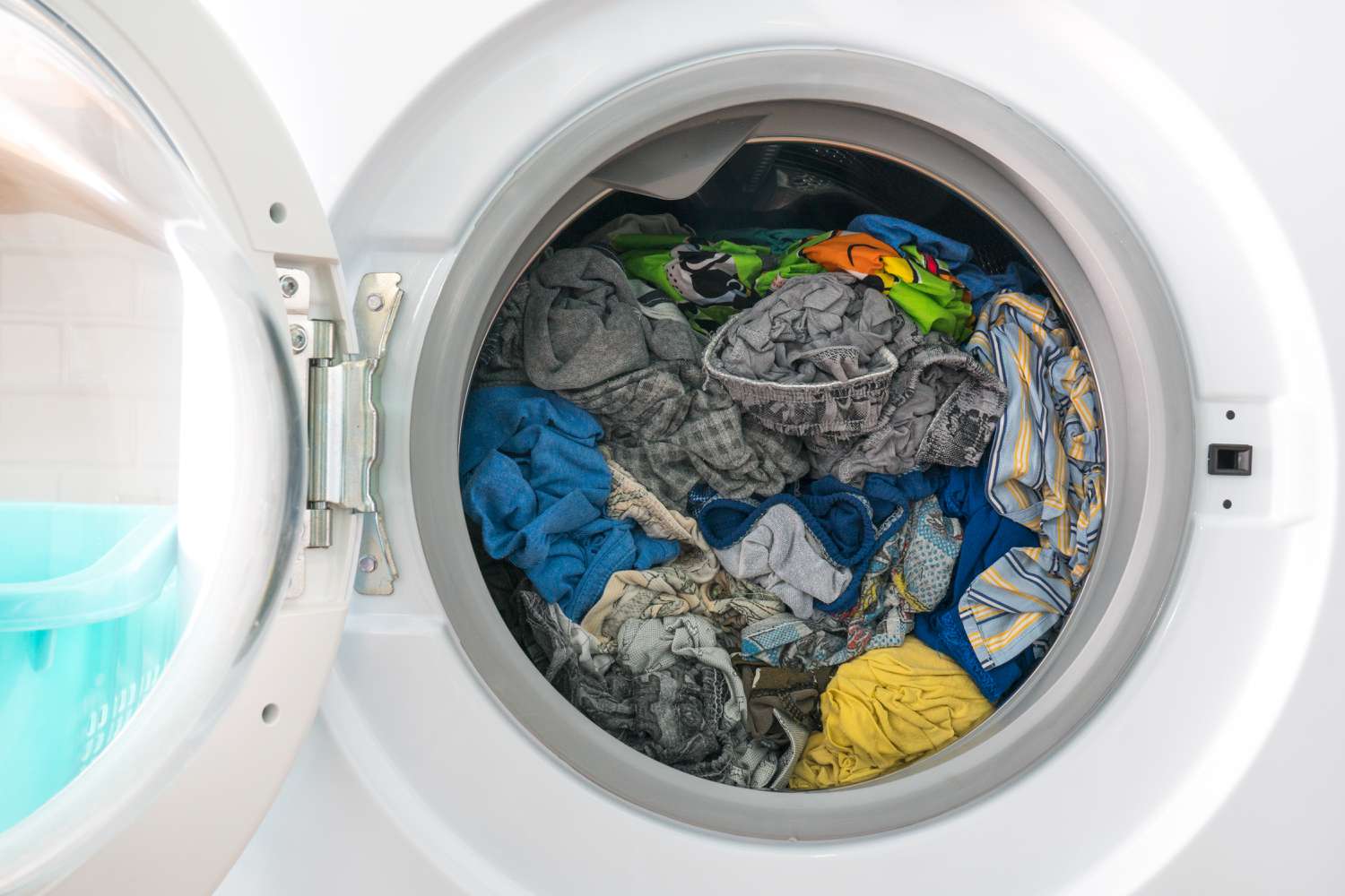 Overloaded dryer drum with clothes packed tightly, preventing proper airflow for efficient drying