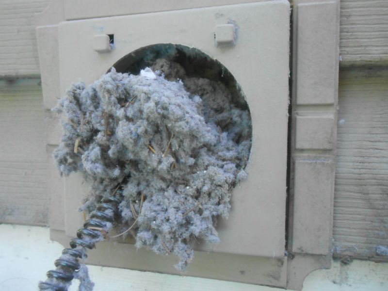 Clogged dryer vent with lint buildup, preventing proper ventilation and extending drying time