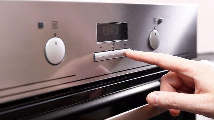 Person resetting a Frigidaire oven by turning it off and on at the control panel